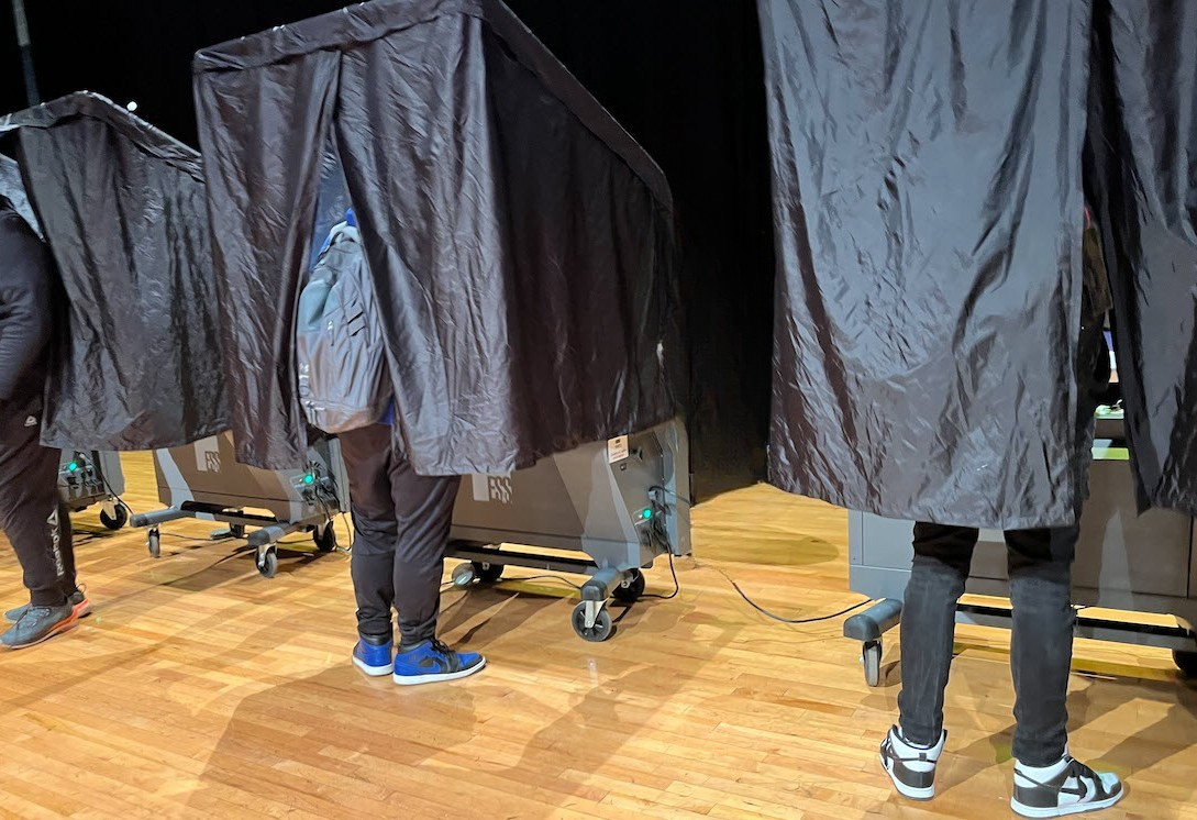 Plainfield High School students cast their votes during a voting simulation event.