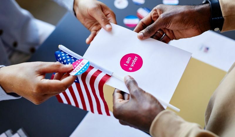 banner-scene-hands-flag-i-voted-sticker-stock-800w.jpg