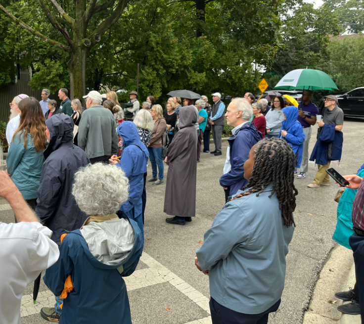 Crowd prepared for rain at the E Revelle honorary sign unveiling