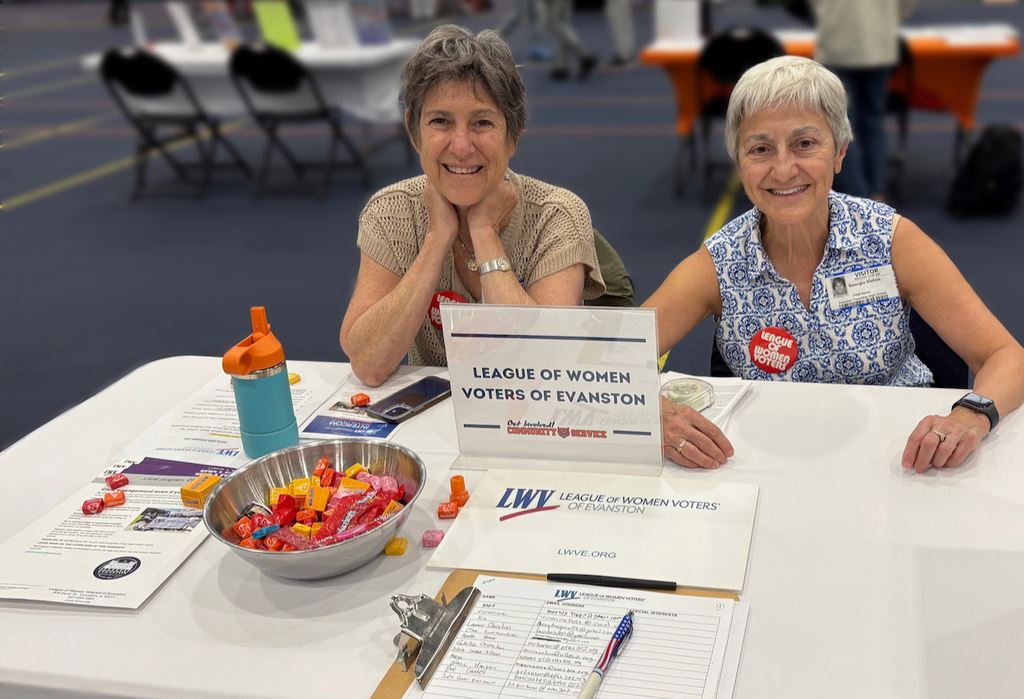 LWVE member Marcia Bogolub and Co-President Georgia Vlahosat at the ETHS Volunteer Fair.