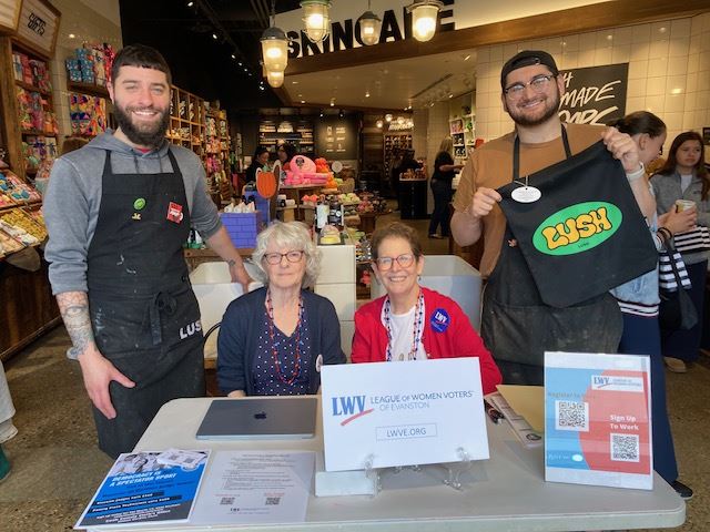Julie Zweigoron, Judy Hoffman, and LUSH employees at the LWVE information table.