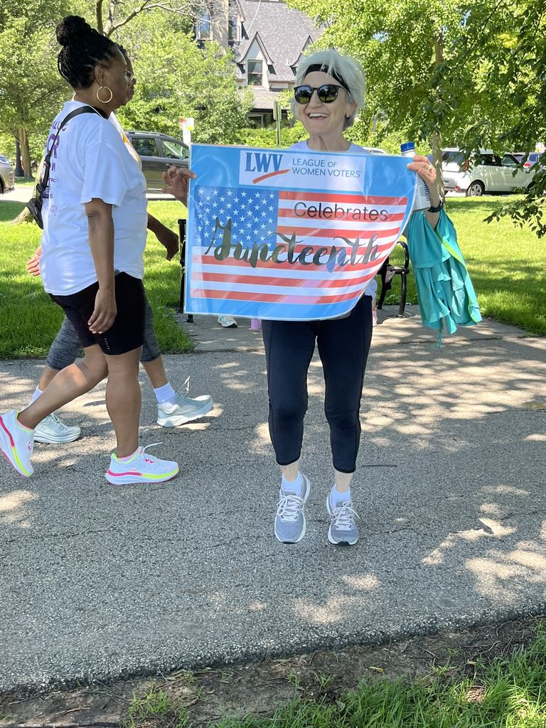 Georgia Vlahos with Juneteenth parade sign