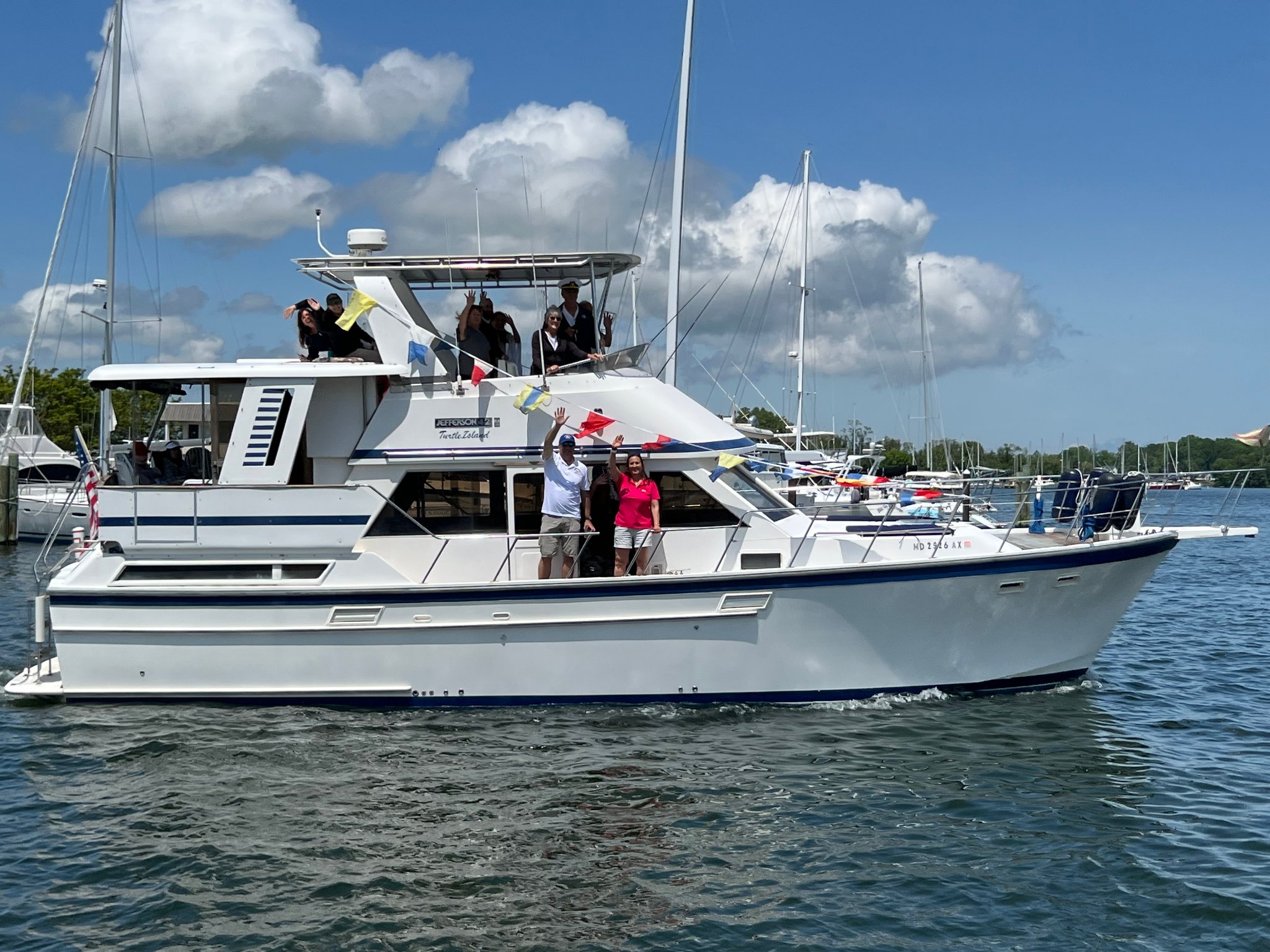 people waving from boat