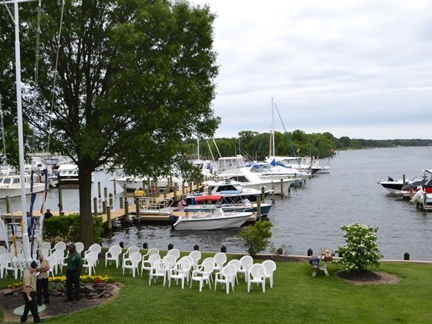 Chairs set up on lawn overlooking pier