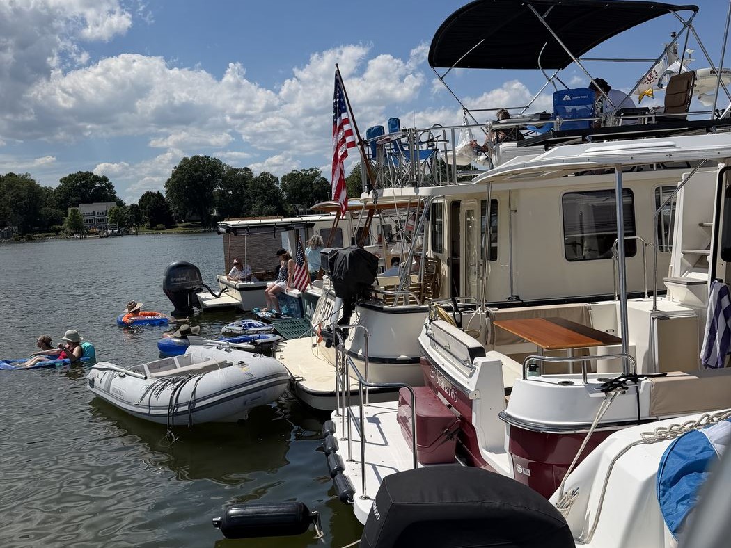 People swimming off boats rafted up together
