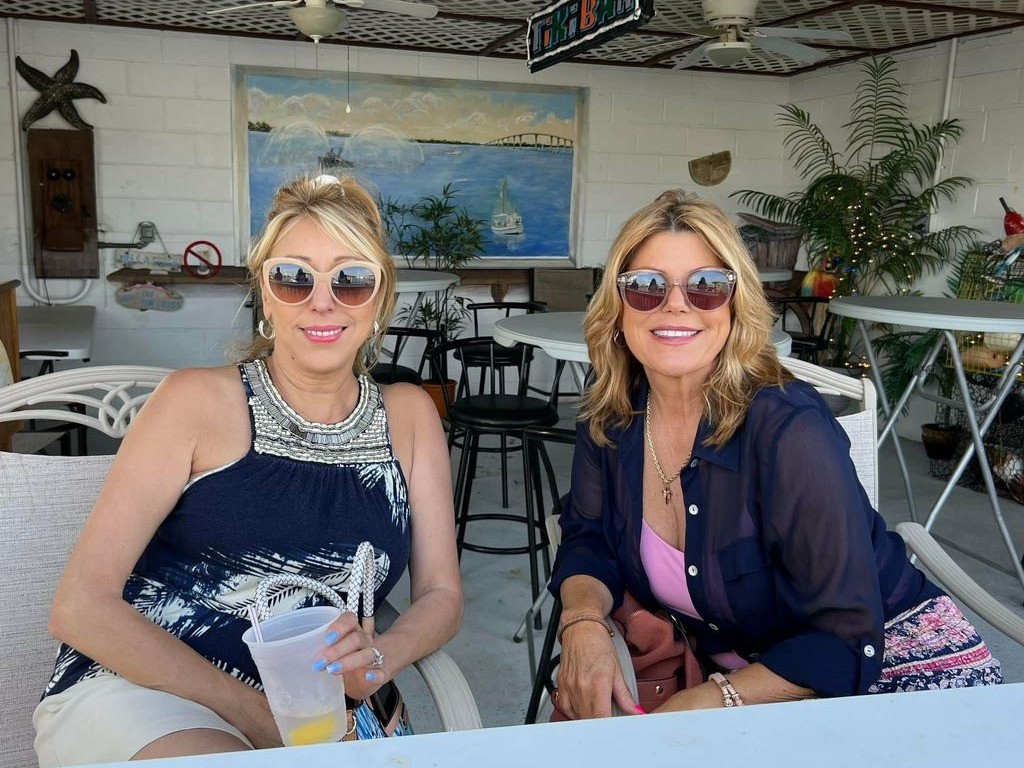 Two ladies sit together in crab shack