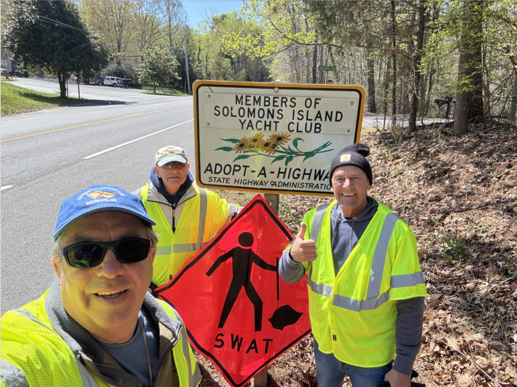 three men picking up litter for adopt a highway