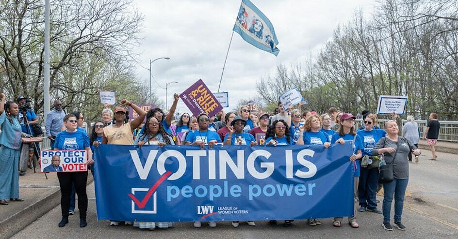 League members rallying with Voting is People Power signs