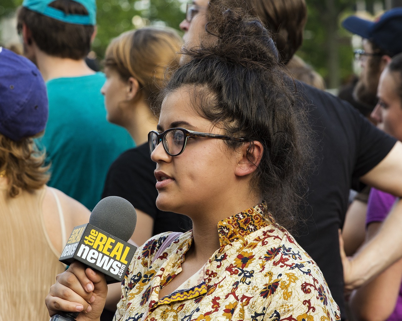 Woman news reporter on site with microphone