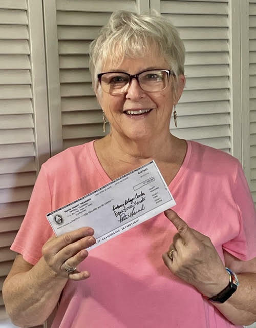 Smiling Woman in pink shirt with envelope