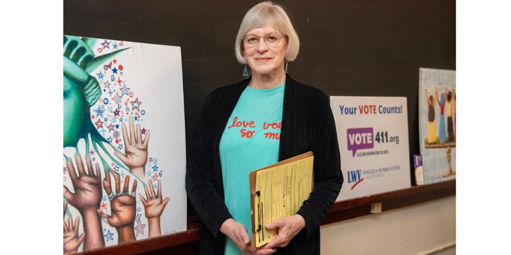 Debbi Voss in front of LWV graphics