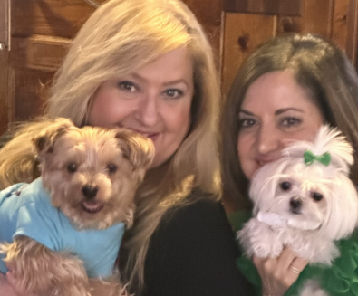 Two women with their pups
