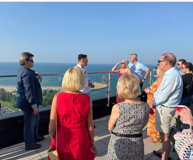 People listening to speaker on a rooftop