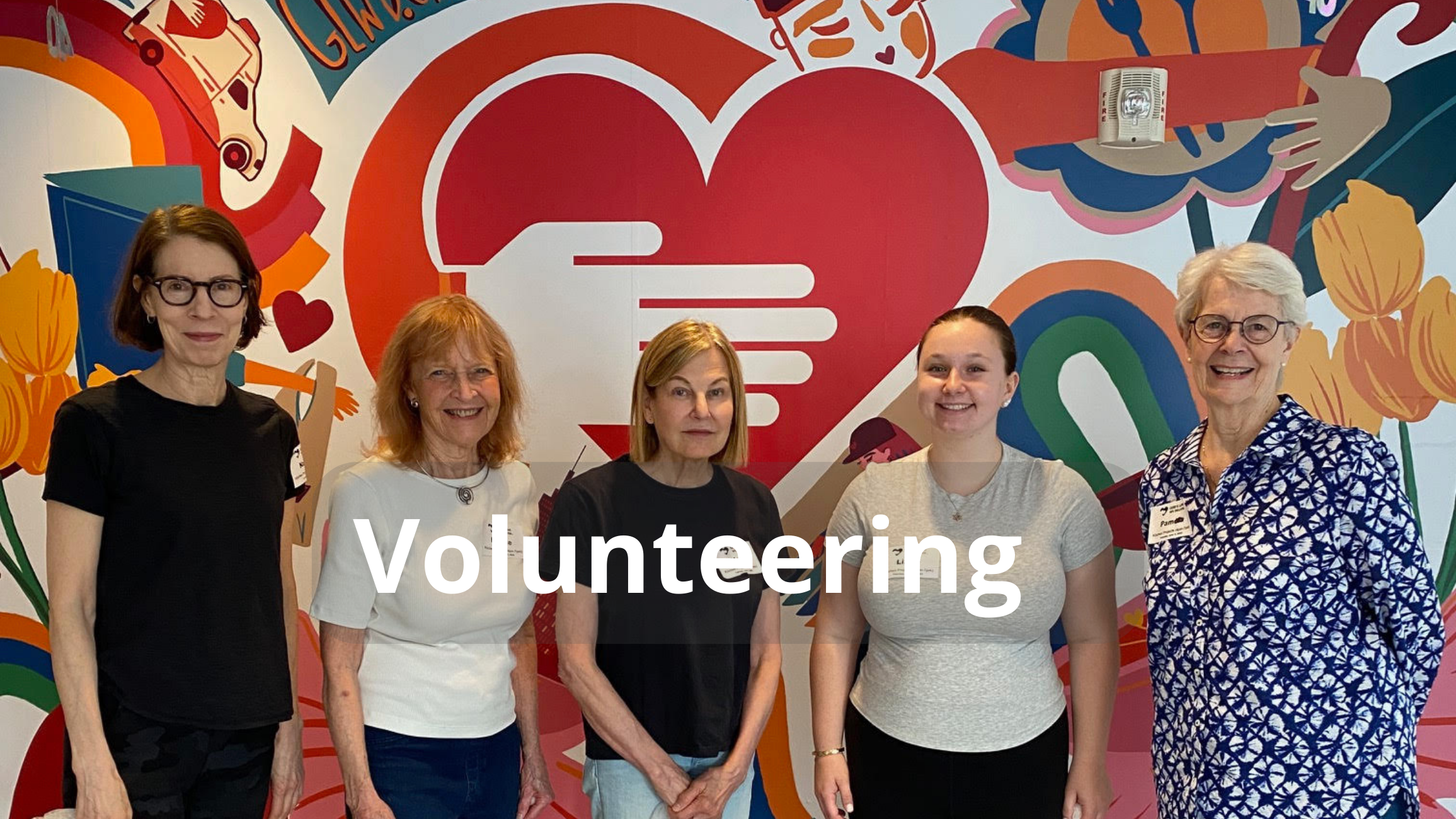 Five members of Women’s Connection who are volunteering in NYC with God’s Love We Deliver smile for 