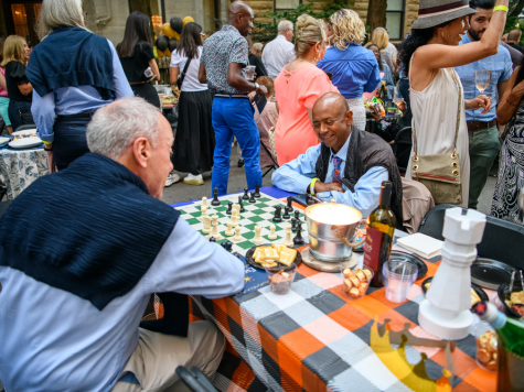 Two men playing chess at party
