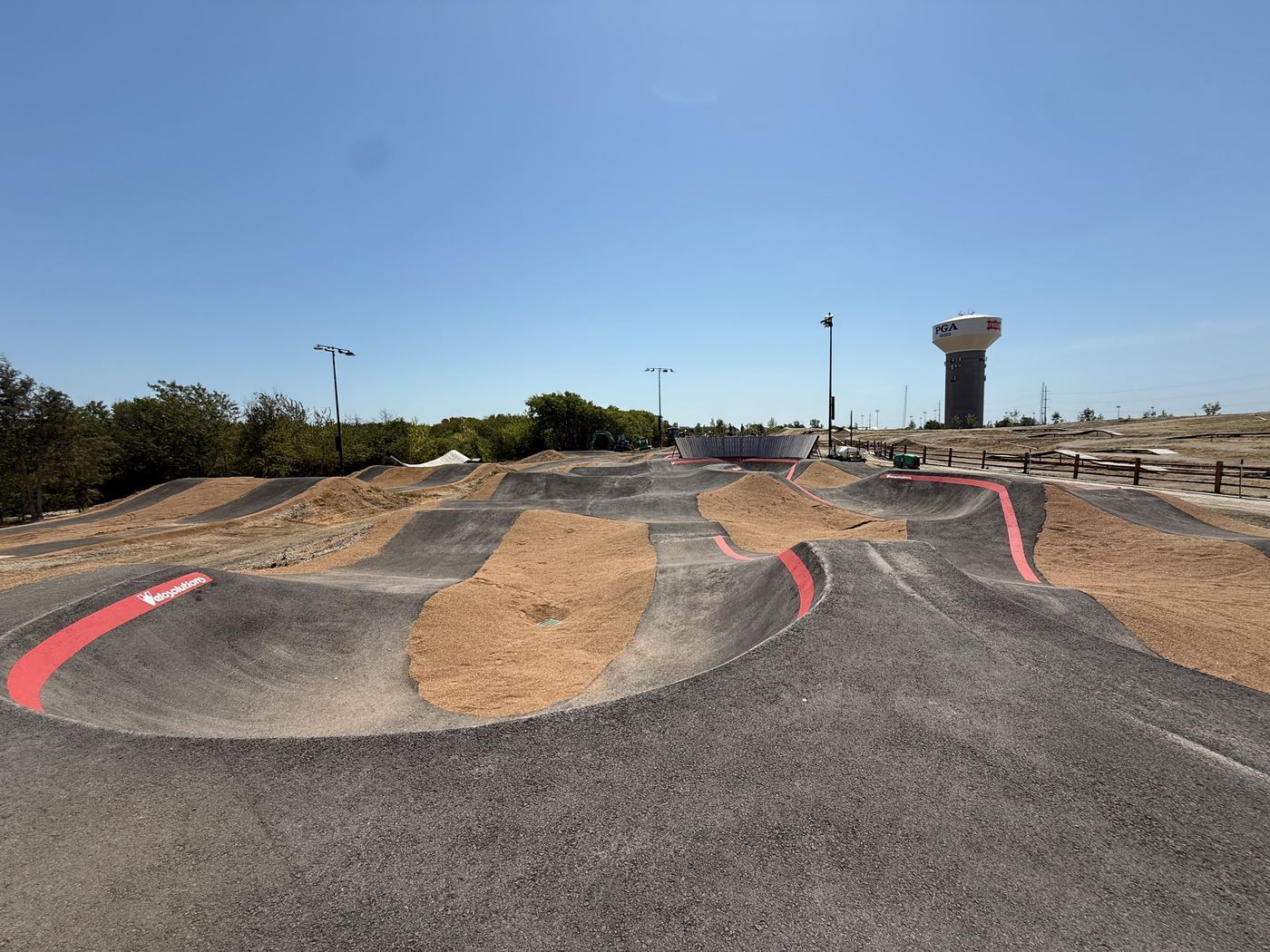 The pump track, with the tower behind it