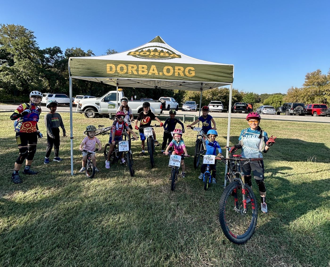 Kids and DORBA volunteers lined up under the DORBA tent before the ride