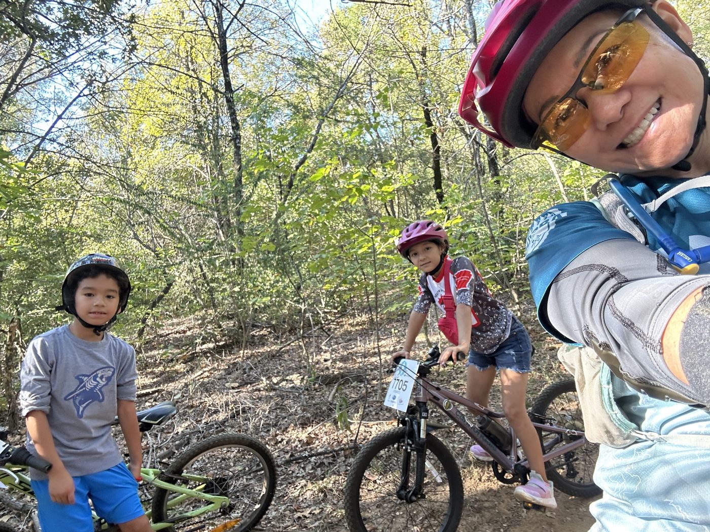 Two kids and a DORBA ride leader on the trail at Horseshoe
