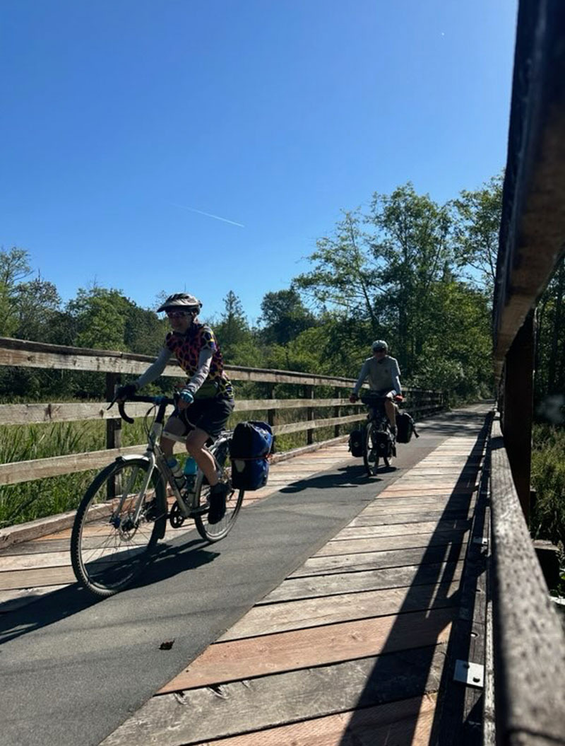 bikepackers on a trail bridge