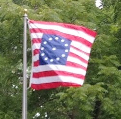 A flag on a pole Description automatically generated with medium confidence