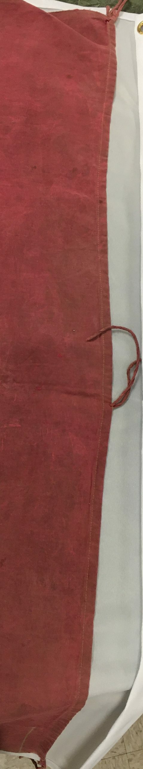 detail of flag hoist with strings attached in three places