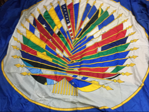 center of OAS flag depicting multiple furled flags
