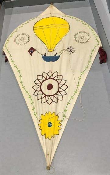 Kite illustrated with a hot-air balloon and other designs