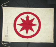 Red compass rose in a circle on a white flag