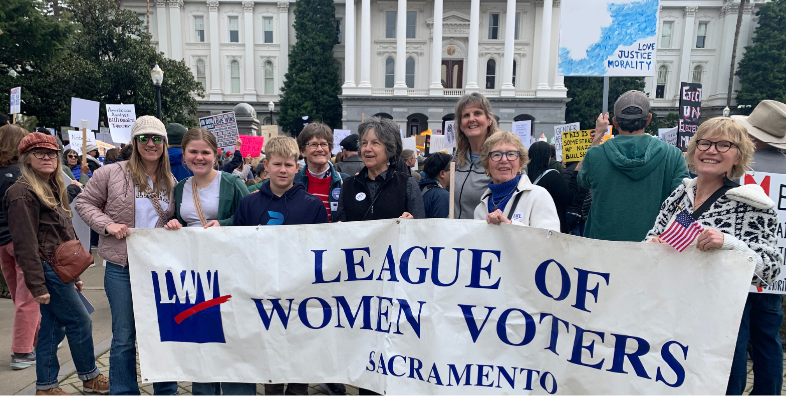 League of Women Voters Sacramento members holding the League banner in front of the California State Capitol