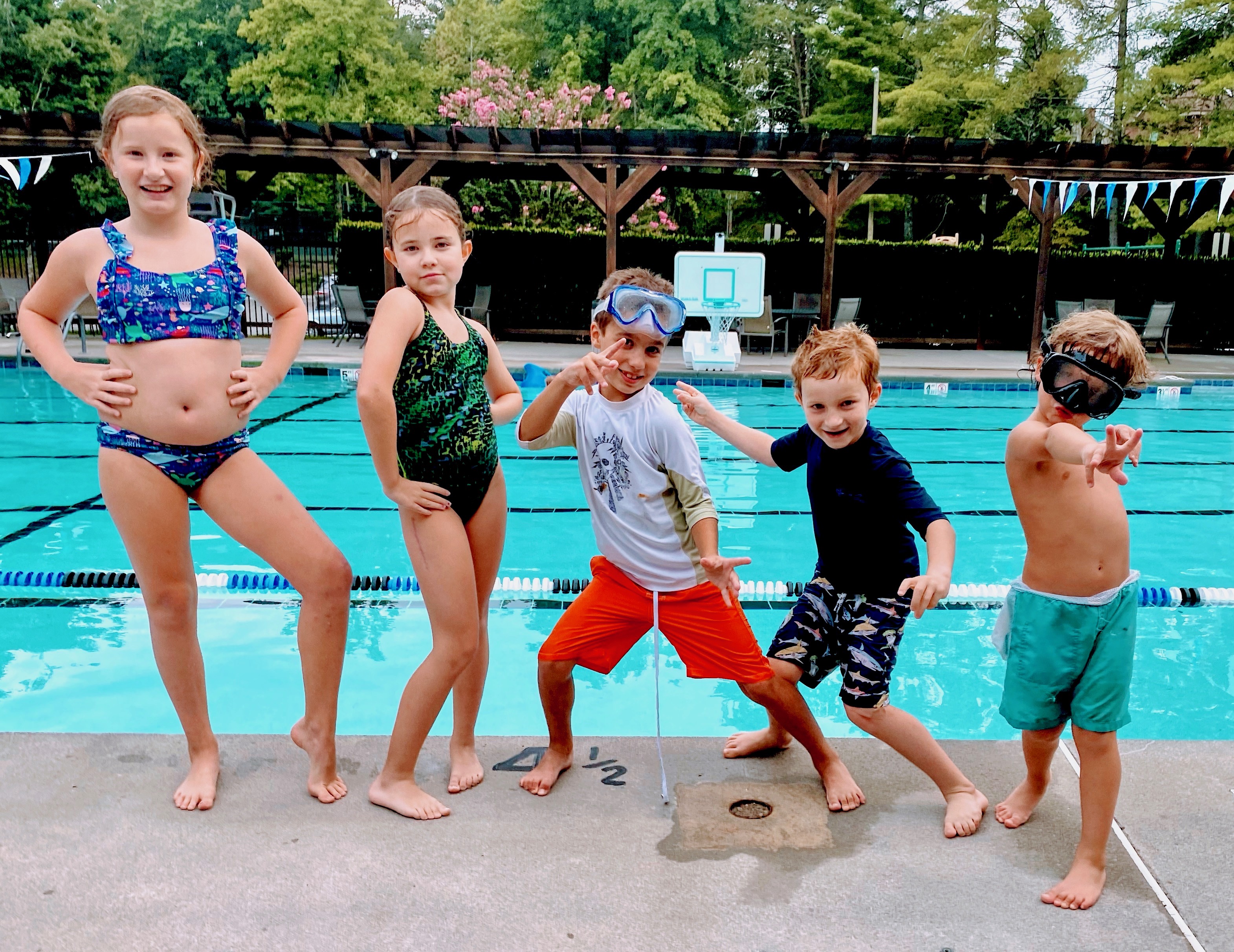 5 posing poolside