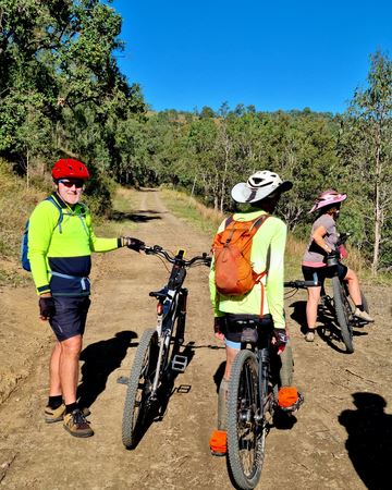 2026 Linville Day 2 - Three Riders Pausing on Dirt Track Through Bush