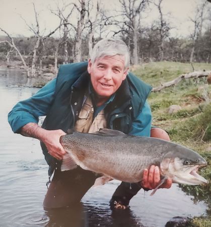 Gerald Gerry Martin smiling with a fly rod