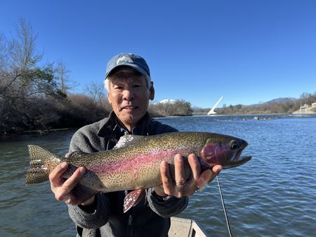 Ron Saiki standing with a fly rod near the water