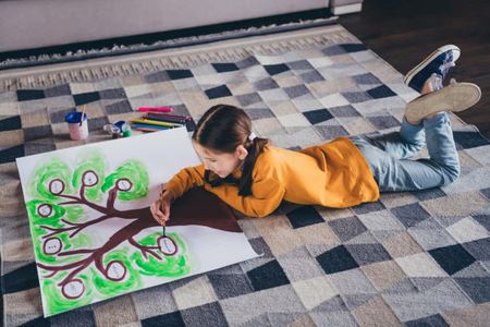 Young girl drawing tree