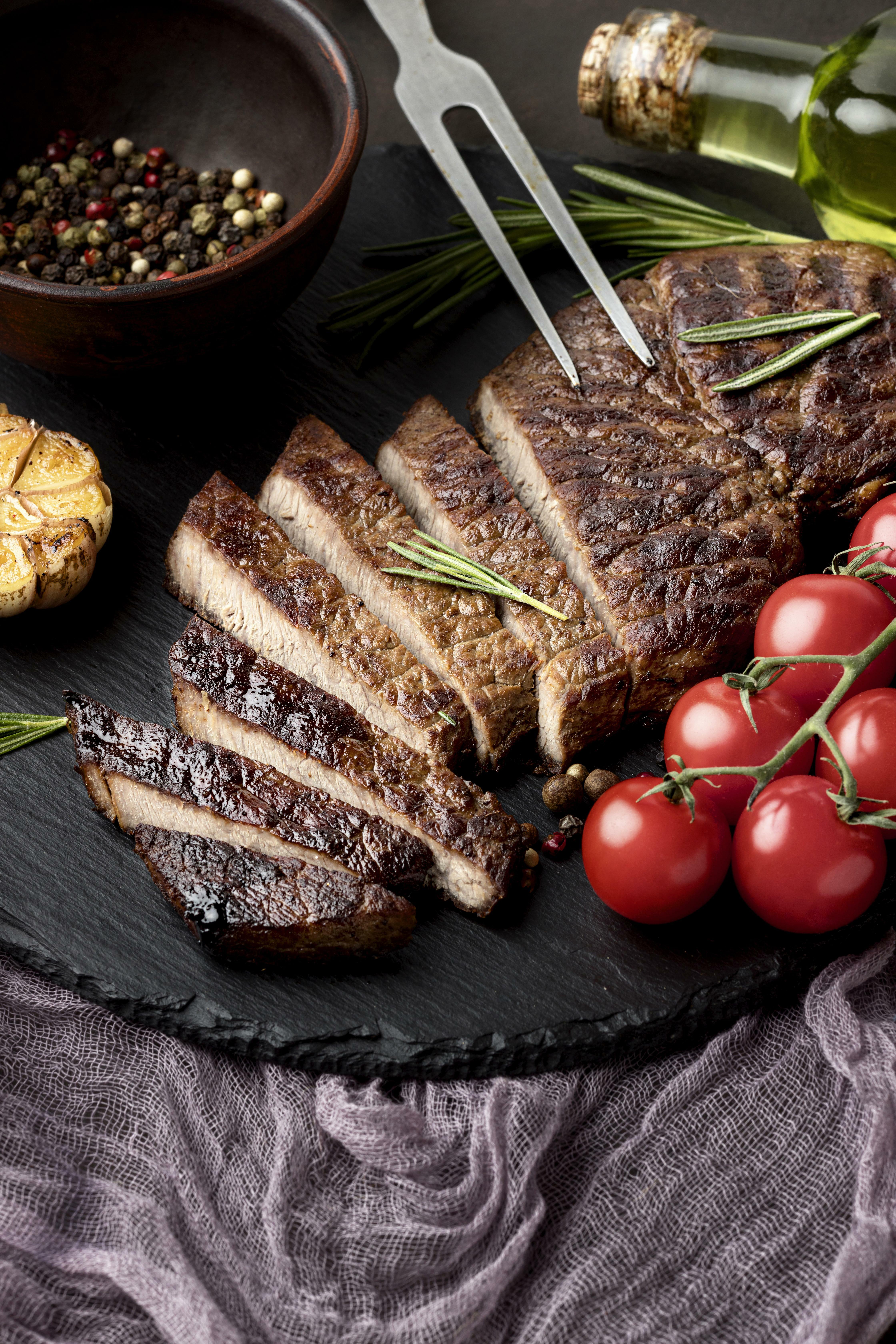 close-up-wooden-board-with-tasty-cooked-meat.jpg