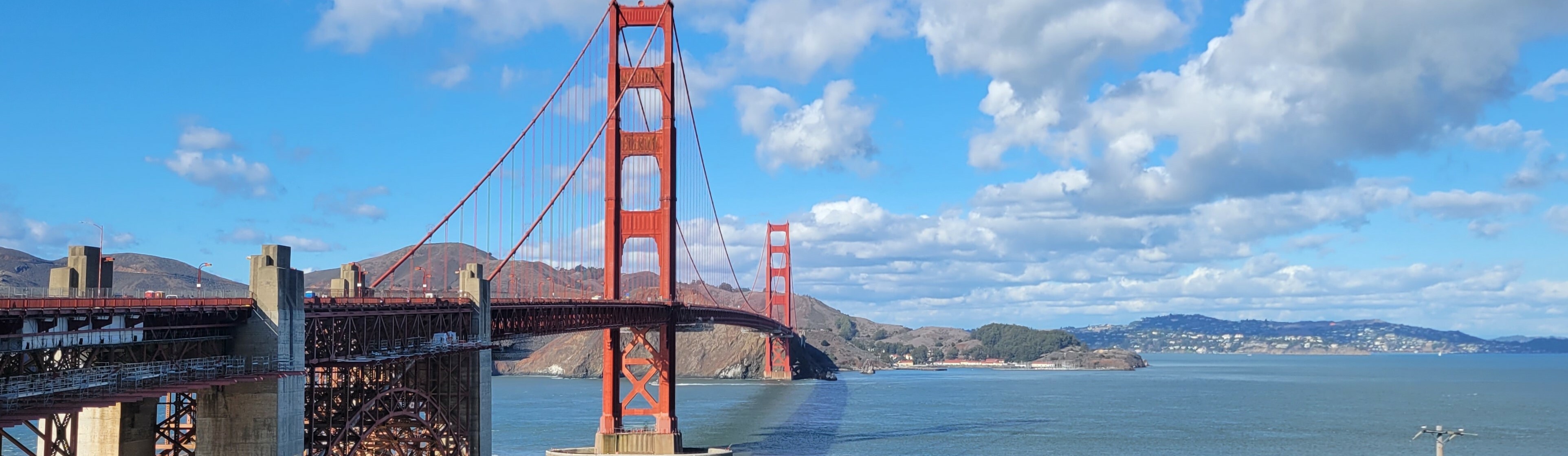Tour guide leading a group with the Golden Gate Bridge in the background