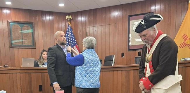 Mother Kathy Prather pinning SAR Rosette on her son.